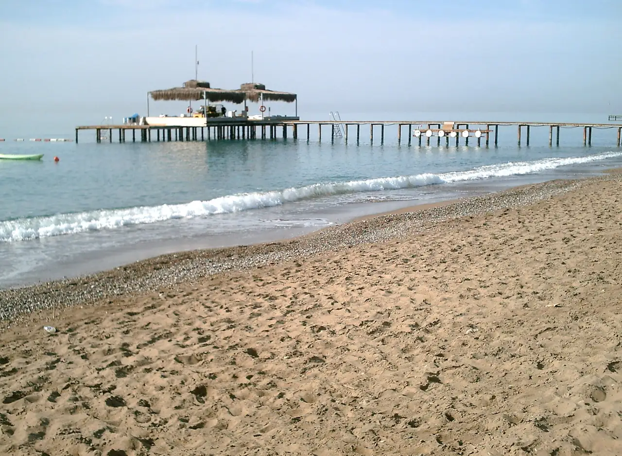 Sandy beach with a wooden pier in Belek