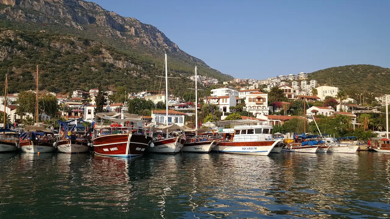 Kaş harbour with boats and white houses on the hillside