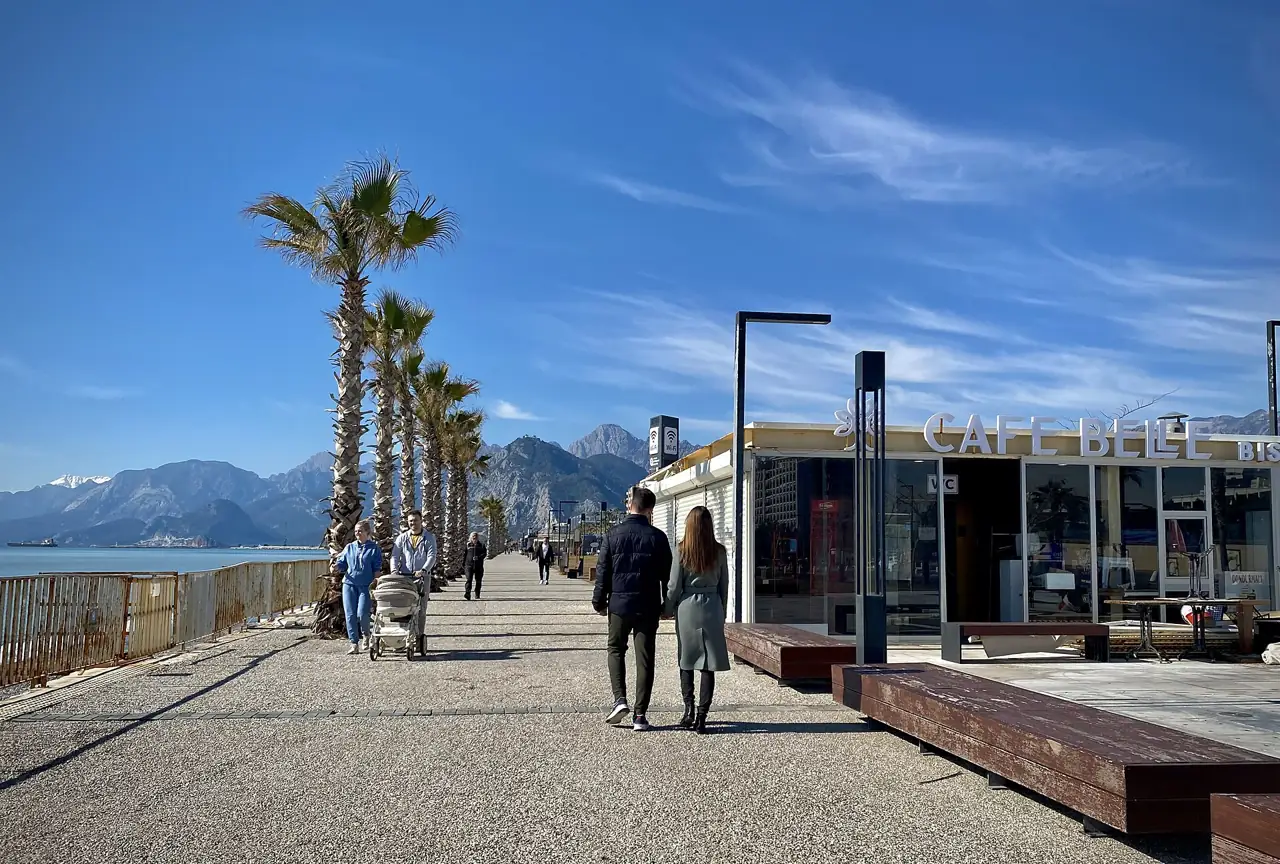 Konyaaltı beach promenade in Antalya with palm trees and the Taurus mountains